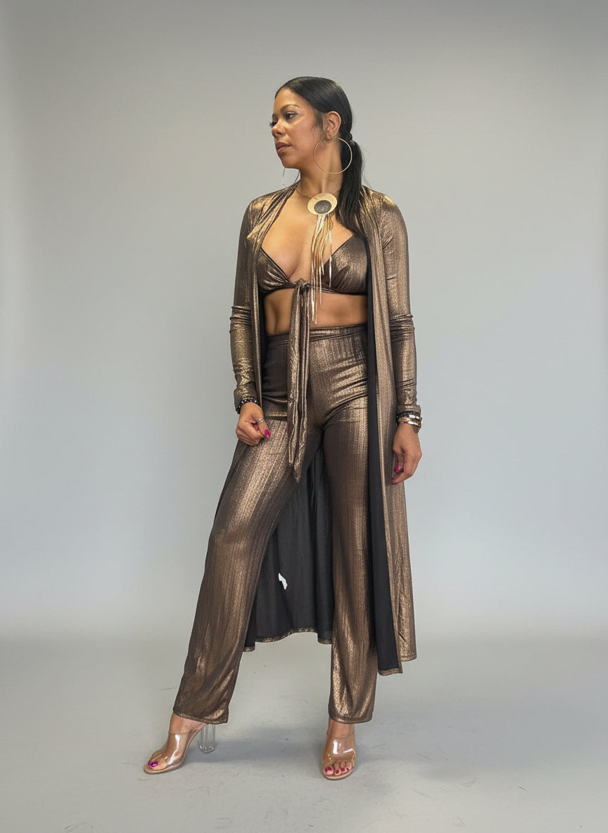 Woman in 3 piece outfit standing in a room with white  wall